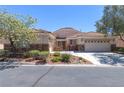 Attractive single-story home featuring desert landscaping, stucco exterior, and a tile roof at 1963 Dakota Lodge Ave, Las Vegas, NV 89123
