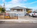 Charming single-story home showcasing a covered porch, well-maintained yard, and convenient driveway parking at 240 Navajo Dr, Henderson, NV 89015