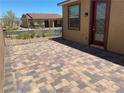 Private outdoor patio perfect for entertaining, featuring elegant pavers and secure perimeter fencing at 2719 Chinaberry Hill St, Laughlin, NV 89029