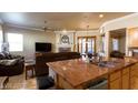 An open kitchen provides seamless flow into a living room and a decorative fireplace at 2740 Carolina Blue Ave, Henderson, NV 89052