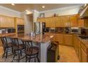 Gourmet kitchen with stainless appliances, granite counters, and breakfast bar seating at 2740 Carolina Blue Ave, Henderson, NV 89052