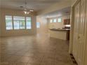 Spacious living room with tile floors and large windows overlooking the yard, open to a kitchen area at 2855 Grande Valley Dr, Las Vegas, NV 89135