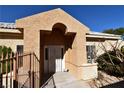 Welcoming front entrance featuring a covered entryway and a charming decorative statue at 325 Wild Plum Ln, Las Vegas, NV 89107