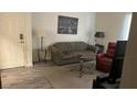 Comfortable living room with olive sofa, recliner chair, side table, and muted tones throughout at 3550 Bay Sands Dr # 3051, Laughlin, NV 89029
