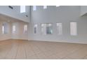 Bright and airy living room with tile flooring and multiple large windows at 3774 Dusky Flycatcher St, Las Vegas, NV 89122