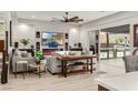 Elegant living room with comfortable seating, media center, fireplace, and view of the outdoor kitchen at 4505 Amazing View St, Las Vegas, NV 89129
