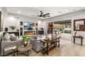 Modern living room with sleek fireplace, large TV, and sliding glass doors to the outdoor kitchen at 4505 Amazing View St, Las Vegas, NV 89129