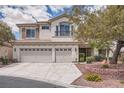 Two-story stucco home featuring a spacious driveway, three-car garage, and desert-friendly landscaping at 4804 Laurentia Ave, Las Vegas, NV 89141