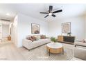 Airy living room featuring modern decor, ceiling fan, and sleek hardwood floors at 50 Armstrong Cir, Henderson, NV 89015