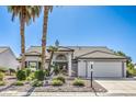 Charming single-story home featuring a well-maintained landscape and an attached two-car garage at 5000 Linkside Dr, Las Vegas, NV 89130