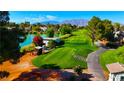 Picturesque golf course with a serene pond and vibrant greenery, offering a tranquil and scenic recreational setting at 5000 Linkside Dr, Las Vegas, NV 89130