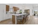 Charming kitchen features white counters, wood and white cabinets, and a stylish lighting fixture at 5000 Linkside Dr, Las Vegas, NV 89130