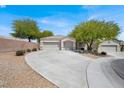 Charming single-story home featuring a three-car garage and a well-maintained front yard with mature trees at 6032 Red Glitter St, North Las Vegas, NV 89031