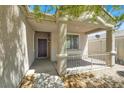 Inviting front porch with decorative columns, wrought iron railing and a stylish dark-colored front door at 6032 Red Glitter St, North Las Vegas, NV 89031