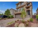 Beautiful stucco home with well-kept landscaping and a brick driveway at 6056 Atlantis Dream Ave, Las Vegas, NV 89139
