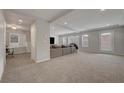 Spacious living room featuring neutral colors, recessed lighting, and plush carpeting at 6056 Atlantis Dream Ave, Las Vegas, NV 89139