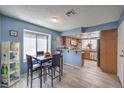 Eat-in kitchen with a dining area offering natural light, stylish flooring, and updated cabinets at 6408 Deadwood Rd, Las Vegas, NV 89108