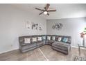 Spacious living room featuring a large sectional couch, modern decor, and bright, airy ambiance at 6408 Deadwood Rd, Las Vegas, NV 89108