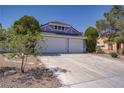 Two-story home featuring a two-car garage and desert landscaping at 6773 Obannon Dr, Las Vegas, NV 89146