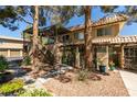 Charming two-story townhouse featuring well-maintained landscaping and a private balcony at 718 Nectarine Ct, Henderson, NV 89014