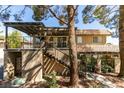 Two-story townhouse exterior with wood staircase leading to large balcony deck above the landscaped front yard at 718 Nectarine Ct, Henderson, NV 89014