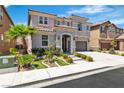 Landscaped front yard with a palm tree of a two-story home featuring a gray stucco and tiled roof at 7545 Fontera Ct, Las Vegas, NV 89139