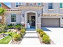 Inviting front porch with a bench, floral wreath, and manicured landscaping leading to the front door at 7545 Fontera Ct, Las Vegas, NV 89139