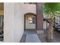Close up of condo entrance with desert landscaping and stairs to upper units at 7885 W Flamingo Rd # 1161, Las Vegas, NV 89147