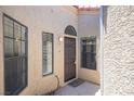 Welcoming entryway featuring neutral paint, two windows that allow plenty of natural light, and a dark wood door at 7911 Canoe Ln, Las Vegas, NV 89145
