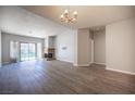 Spacious living room with neutral paint, a brick fireplace, and sliding glass door providing access to the backyard at 7911 Canoe Ln, Las Vegas, NV 89145