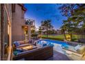 Backyard oasis showcasing a sparkling pool, comfortable lounging area, and an inviting fire pit at 7940 Castle Pines Ave, Las Vegas, NV 89113