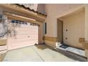 Close up of home's front door, two-car garage, and front yard desert landscaping at 8396 Pearl Beach Ct, Las Vegas, NV 89139