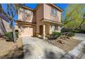Inviting two-story home with an attached garage, desert landscaping, and covered front porch at 8396 Pearl Beach Ct, Las Vegas, NV 89139