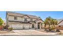 Two-story home with a three-car garage and manicured landscaping on a sunny day at 8516 Canyon Ranch St, Las Vegas, NV 89131