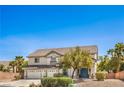 Two-story home with a three car garage, tiled roof, and manicured landscaping at 8516 Canyon Ranch St, Las Vegas, NV 89131