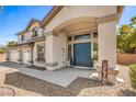 Home's front door is a double door with nice landscaping and a covered entry way at 8516 Canyon Ranch St, Las Vegas, NV 89131