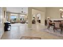 Spacious living and dining areas featuring tile floors, neutral walls, and large windows at 8608 Willow Cabin St, Las Vegas, NV 89131