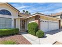 Charming home featuring a well-manicured lawn and a convenient two-car garage at 8761 Anchor Point Ave, Las Vegas, NV 89117