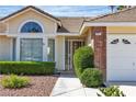 Inviting home exterior with a well-kept lawn and traditional design elements at 8761 Anchor Point Ave, Las Vegas, NV 89117