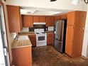 A kitchen with stainless steel appliances and wooden cabinets, in a single Gathering home at 8813 Pavia Dr, Las Vegas, NV 89117
