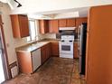A kitchen with stainless steel appliances and wooden cabinets, next to a window at 8813 Pavia Dr, Las Vegas, NV 89117