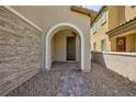 Inviting front porch with stone accents and tiled walkway leading to a dark wood front door at 8873 Howell St, Las Vegas, NV 89166