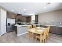 Bright, open kitchen with stainless steel appliances, gray cabinets, and a dining area at 8873 Howell St, Las Vegas, NV 89166