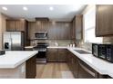Bright kitchen featuring stainless steel appliances, stone backsplash, white countertops and modern cabinetry at 8873 Howell St, Las Vegas, NV 89166