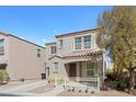 Charming two-story home featuring a covered porch and a well-maintained front yard at 9174 Mcginnis Ave, Las Vegas, NV 89148