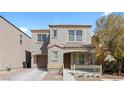 Charming two-story home featuring a covered porch and a well-maintained front yard at 9174 Mcginnis Ave, Las Vegas, NV 89148