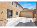 Spacious backyard with a concrete patio, a detached garage, and ample space for recreation at 992 Wagner Valley St, Henderson, NV 89052