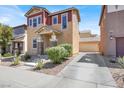 Inviting two-story home featuring a convenient driveway leading to a detached garage at 992 Wagner Valley St, Henderson, NV 89052
