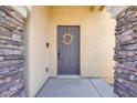 Close-up of the front door with stone pillars and a decorative wreath at 992 Wagner Valley St, Henderson, NV 89052