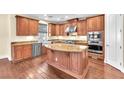 Gourmet kitchen with granite countertops, stainless steel appliances, and a large island at 1 Corte Belleza, Henderson, NV 89011